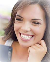 three young girls outside and smiling